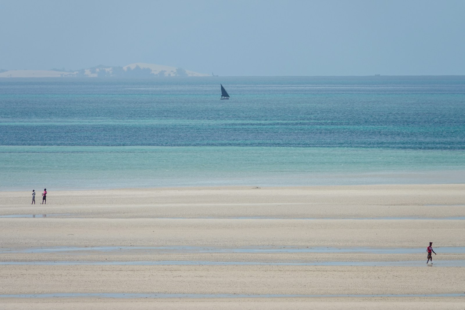 Sailboat off a sandy beach in the Quirimbas