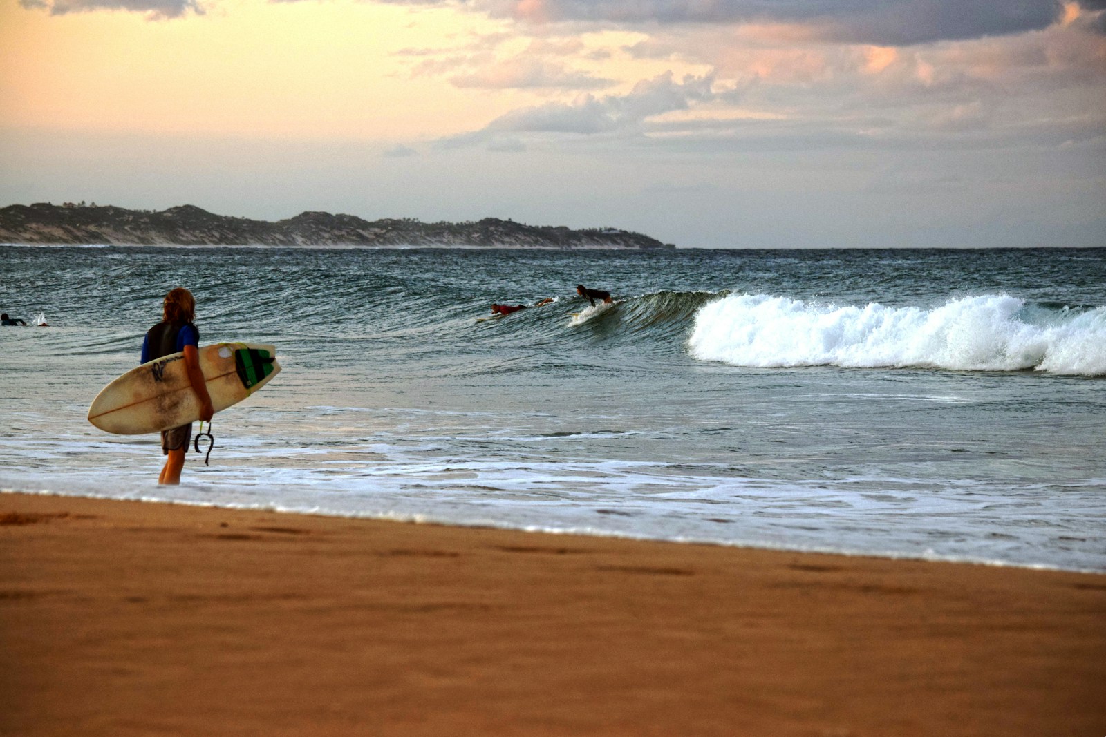 Surfer walking on Tofo Beach, Mozambique
