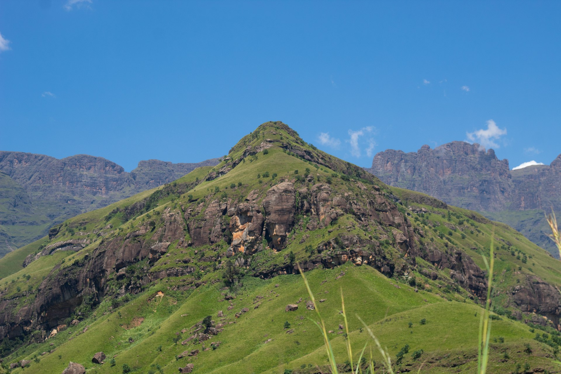 A large green Drakensberg mountain rising into the sky