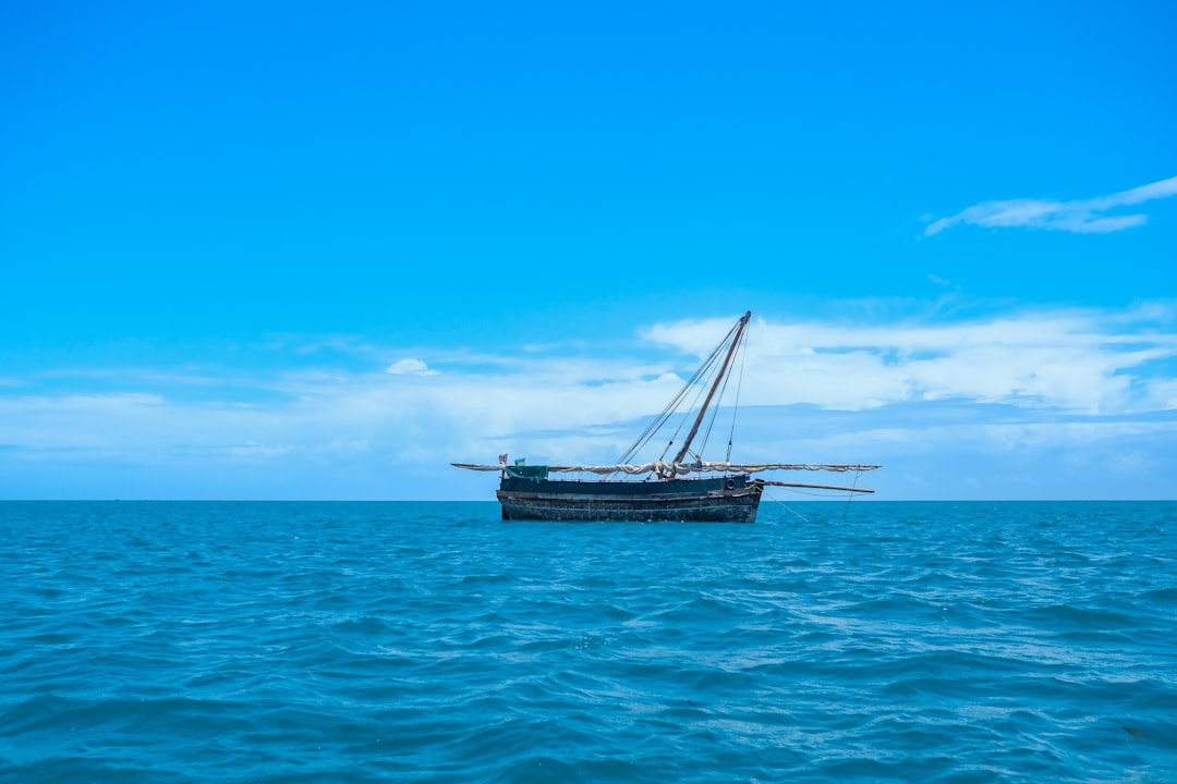 A traditional wooden dhow under sail — evocative of Lamu Island's Swahili maritime culture, Kenya