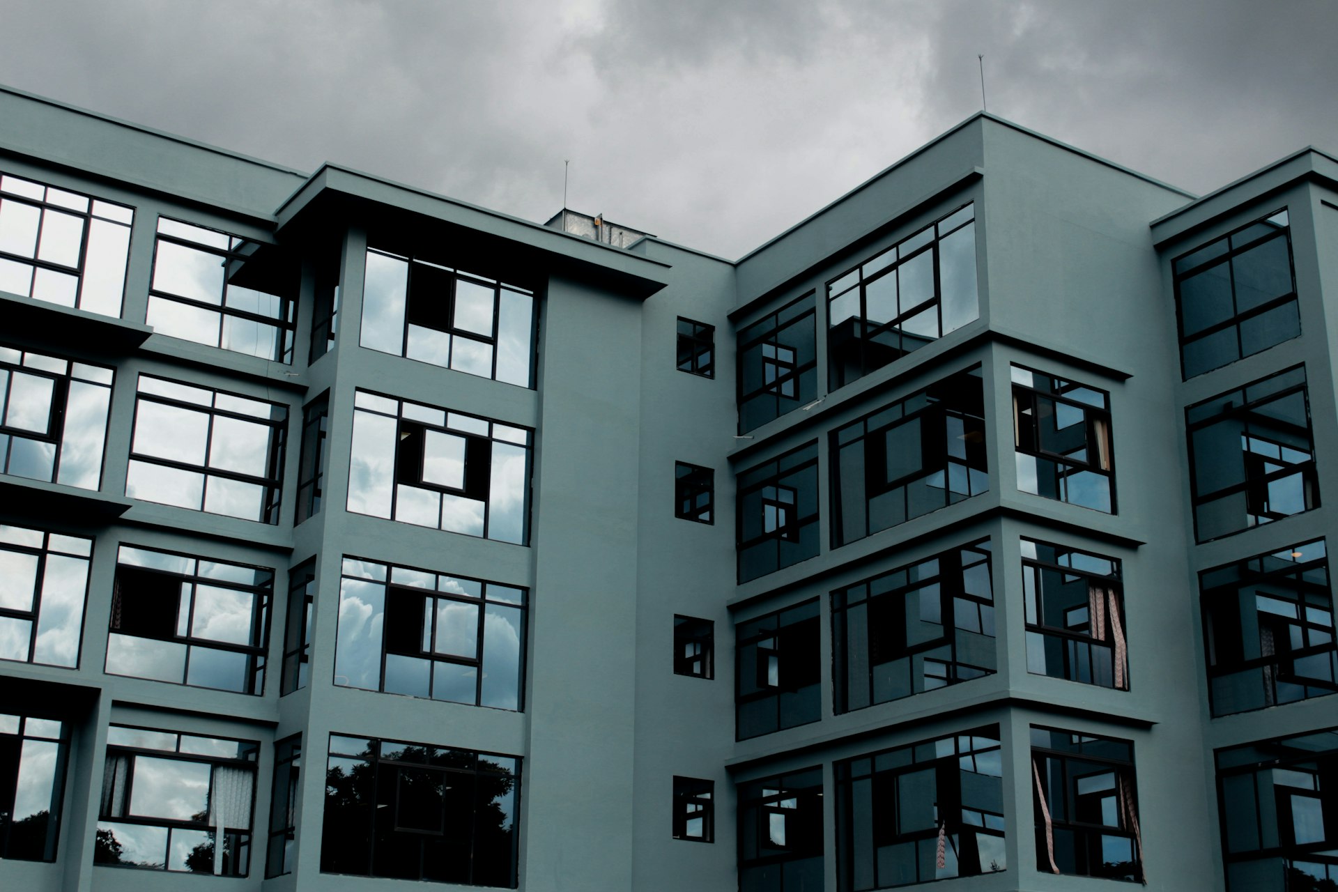 A modern apartment building in Lilongwe under a stormy sky