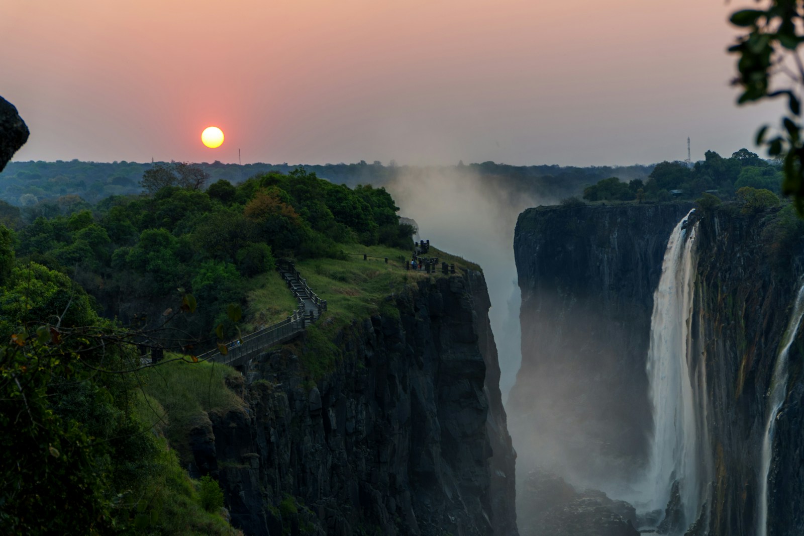 Sunset over Victoria Falls with misty spray