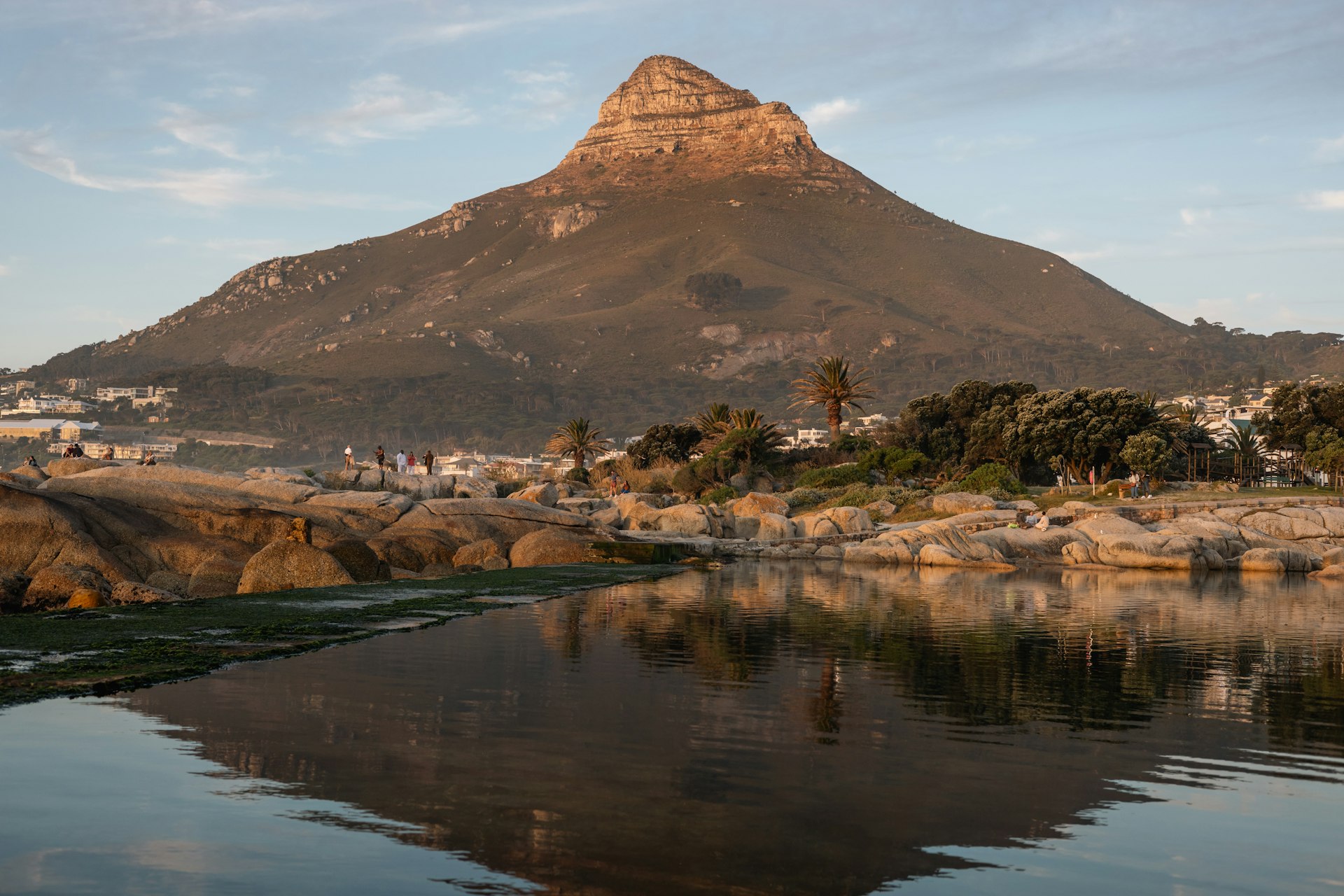 A mountain reflected in still water at sunrise